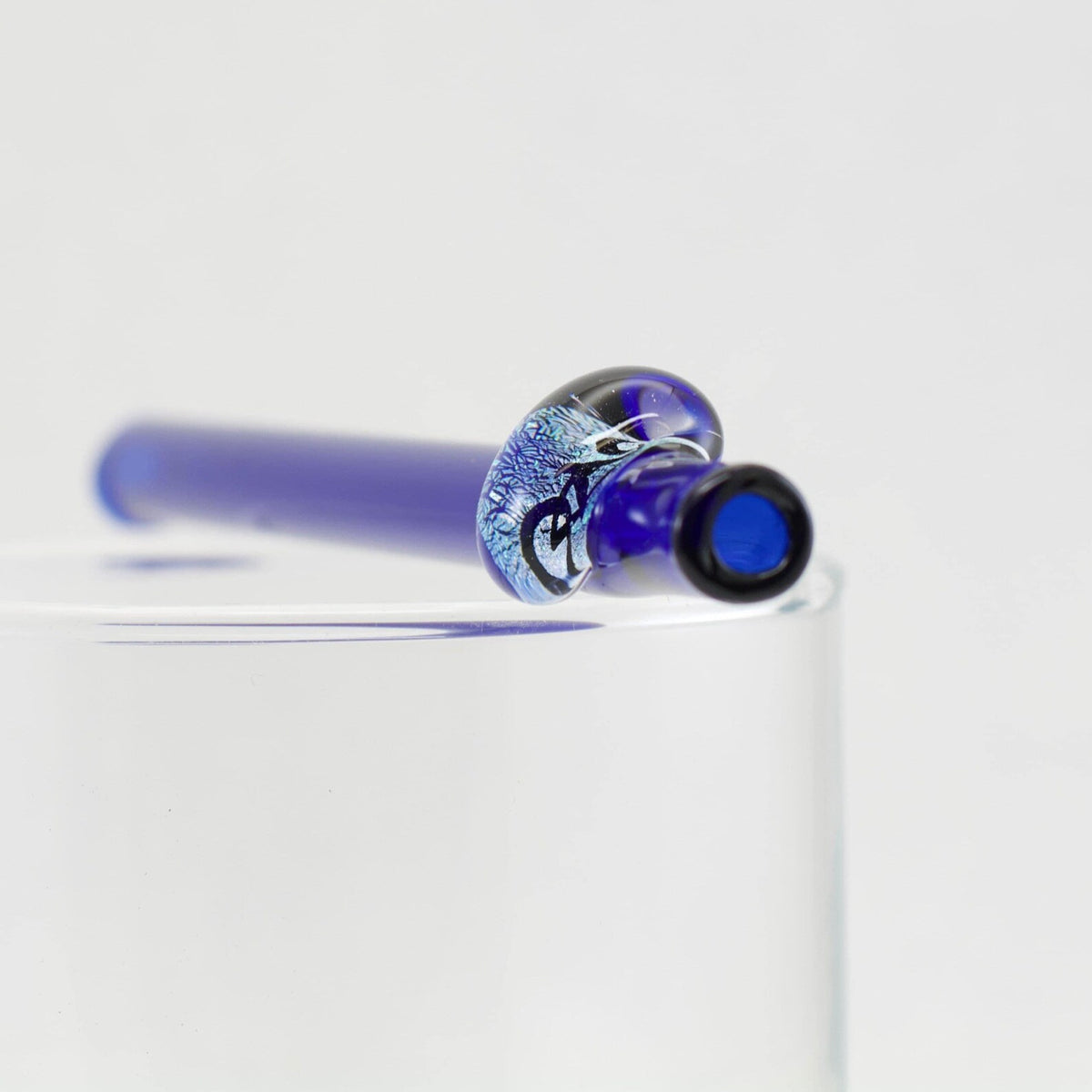 Blue and silver glass straw on a white background