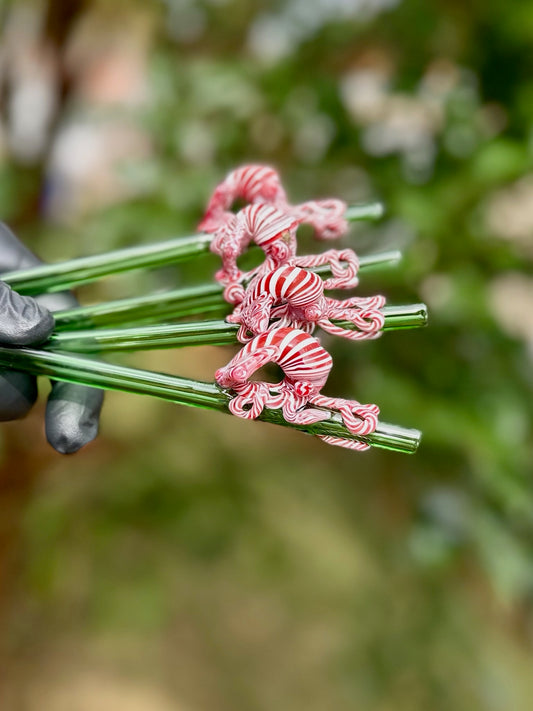 Handful of emerald green glass straws with red and white swirl squid