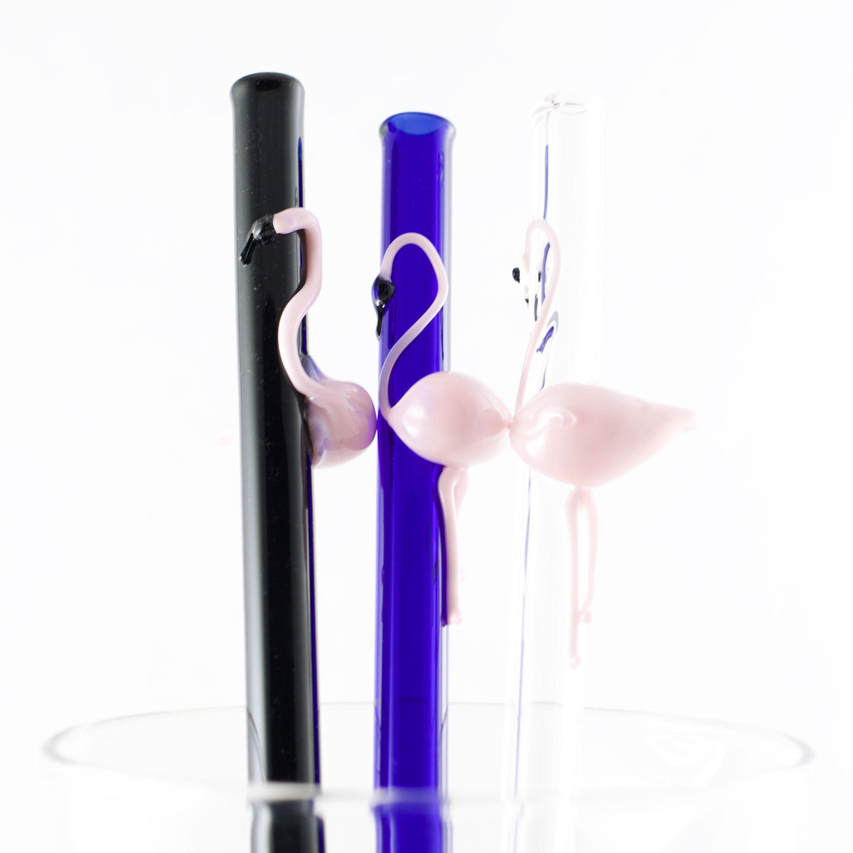 Two straws with flamingos on a white background