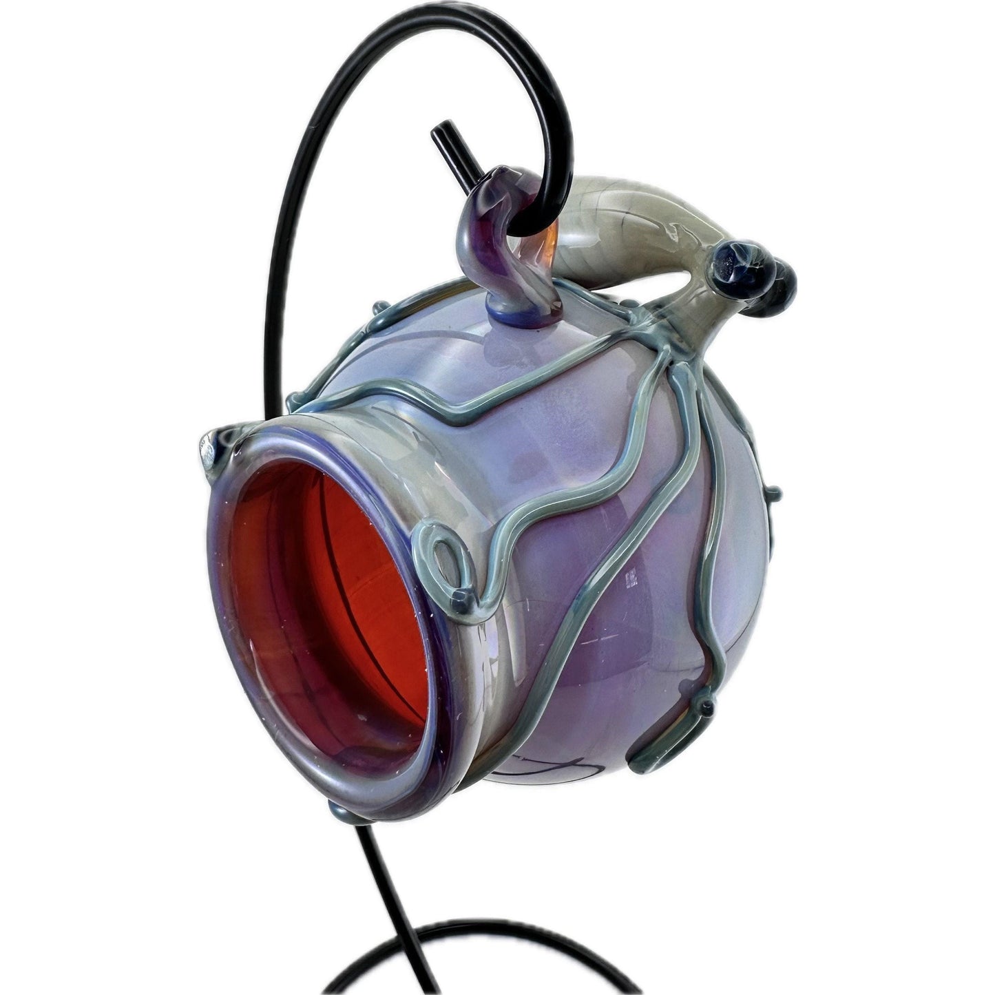 Glass terrarium with purple and red interior and octopus sculpture on a white background