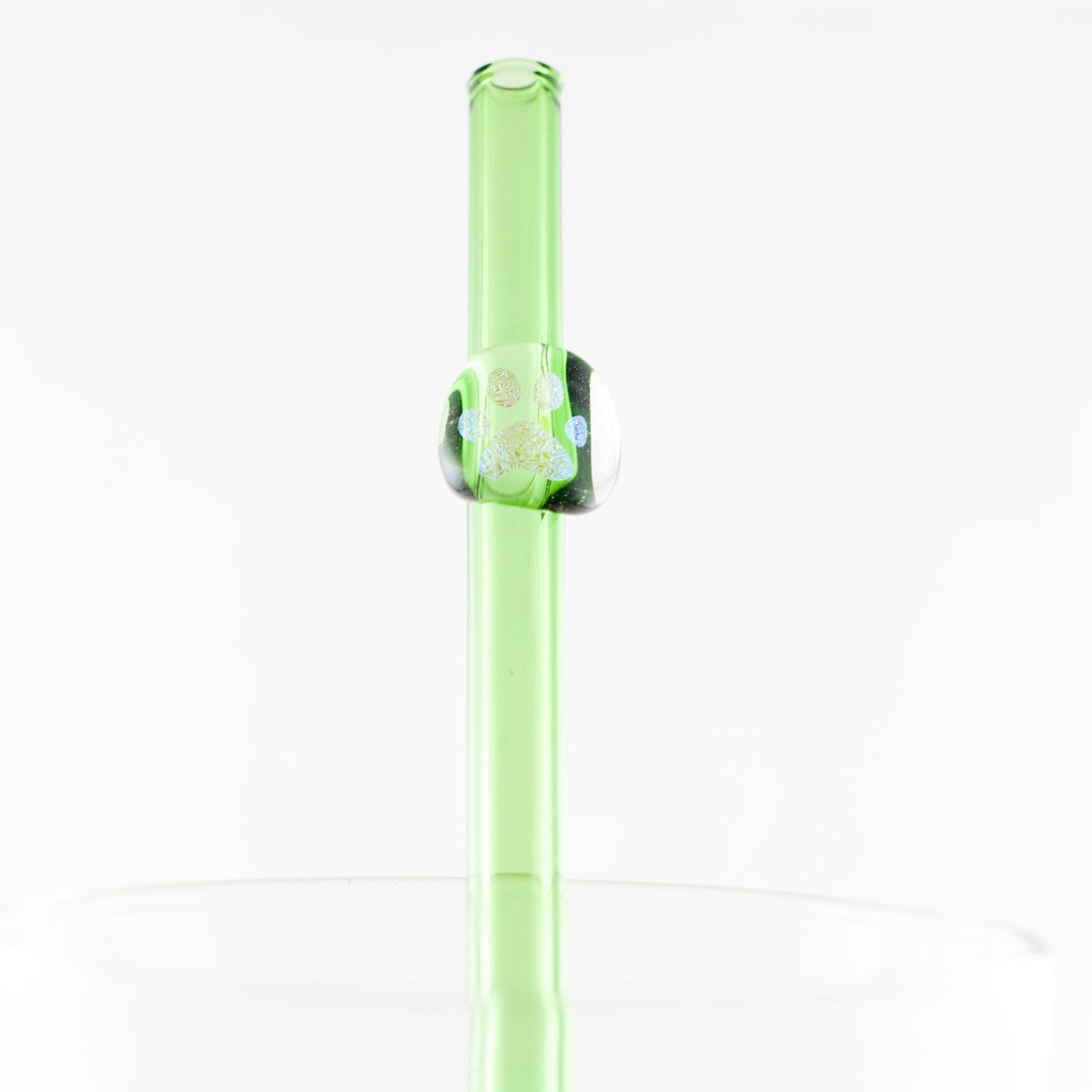 Green straw with a decorative paw print on a white background