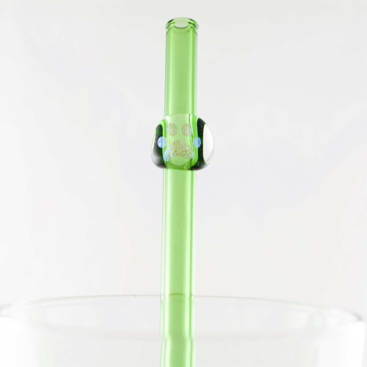 Green straw with a paw print on a white background