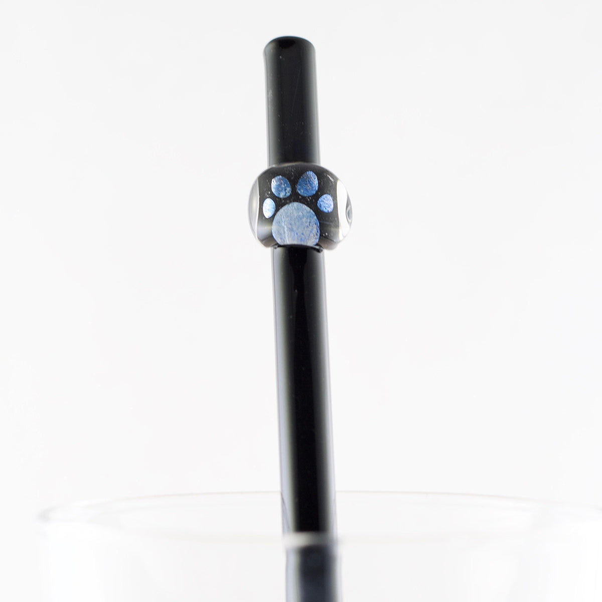 Black straw with a paw print design on a white background